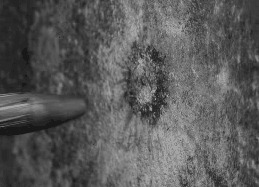 Замедленное изображение пули, разбивающейся о стену. 