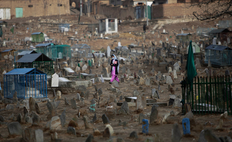 Афганская девочка идет по кладбищу на окраине Кабула, 25 ноября 2009. 