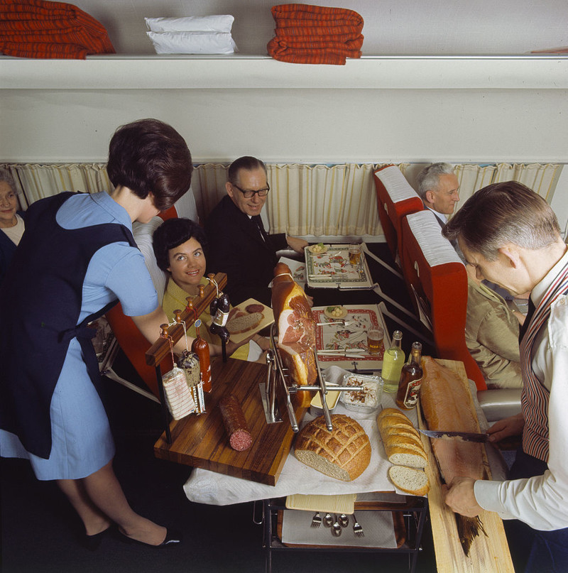 Стюардесса Scandinavian Airlines накрывает шведский стол для своих клиентов в 1969 году.