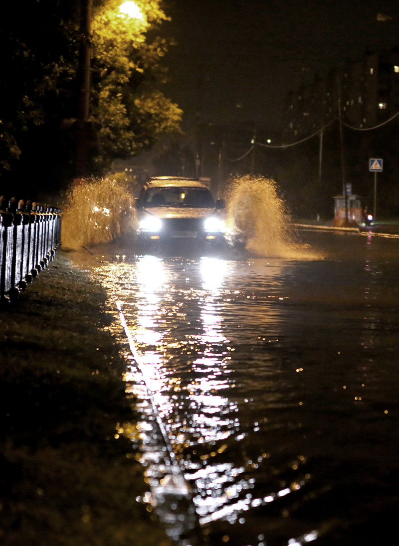 Преодоление затопленной части улицы после урагана в Москве