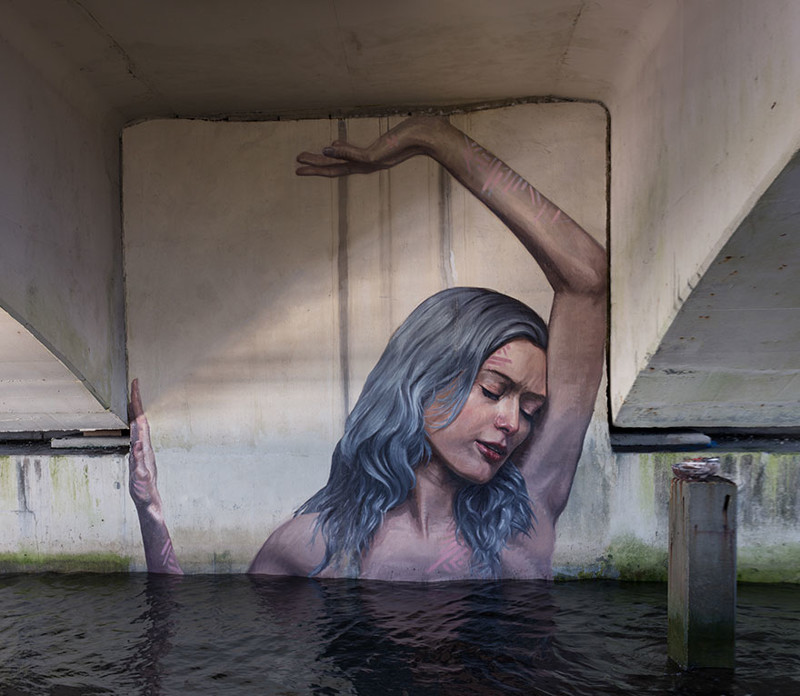 Художник рисует потрясающие картины у воды, стоя на доске для серфинга