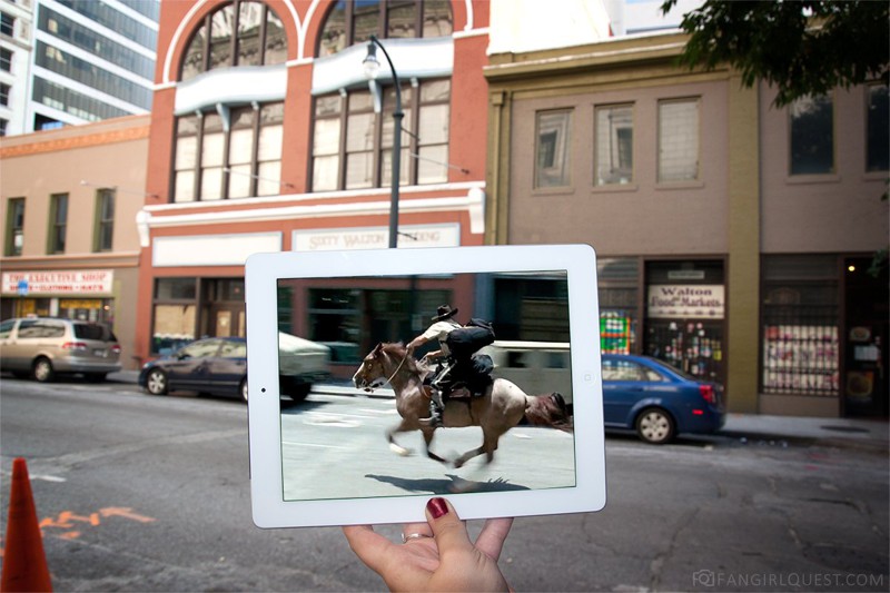 Рик верхом на коне пытается уйти от ходячих, которые захватили город.