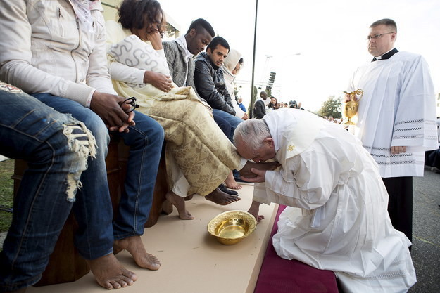 Папа Римский целует ноги беженцам