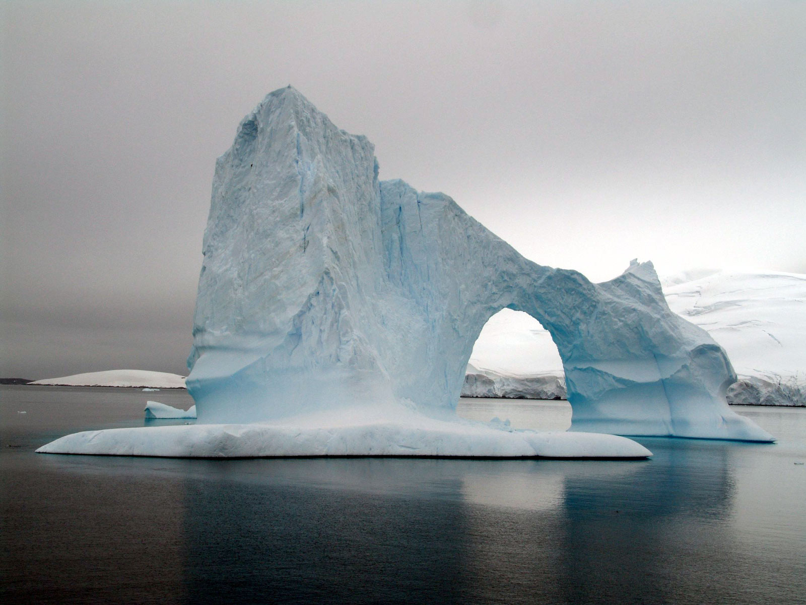 Глыба льда на воде. Пирамидальные айсберги. Ледяные скалы. Ледяные горы. Скалы Антарктиды.