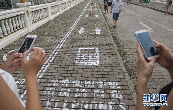 10. В Китае есть специальная разметка на тротуаре для пешеходов со смартфонами