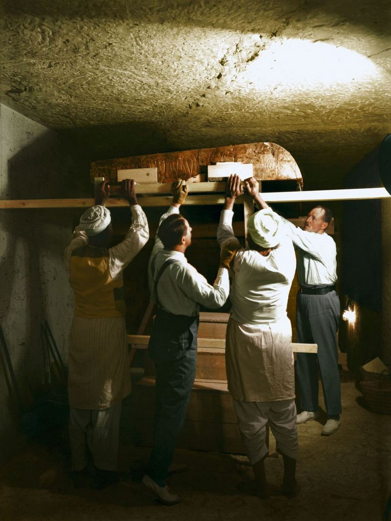Картер, Каллендер и двое египетских рабочих разбирают один из золотых ковчегов в погребальном покое. (1923 г.)