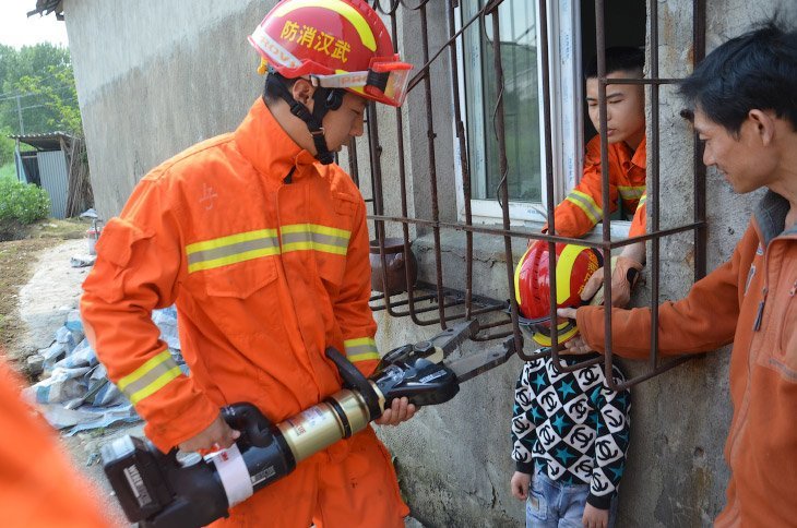 Зачем ты сюда залез? Спасатели в Ухане вытаскивают застрявшего мальчика, провинция Хубэй, Китай
