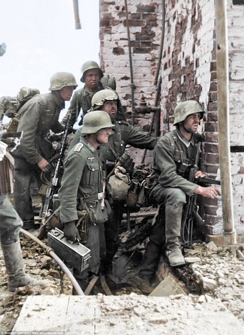 Немецкие солдаты, несущие пулемет MG 34, готовятся нанести удар по советской позиции в Сталинграде