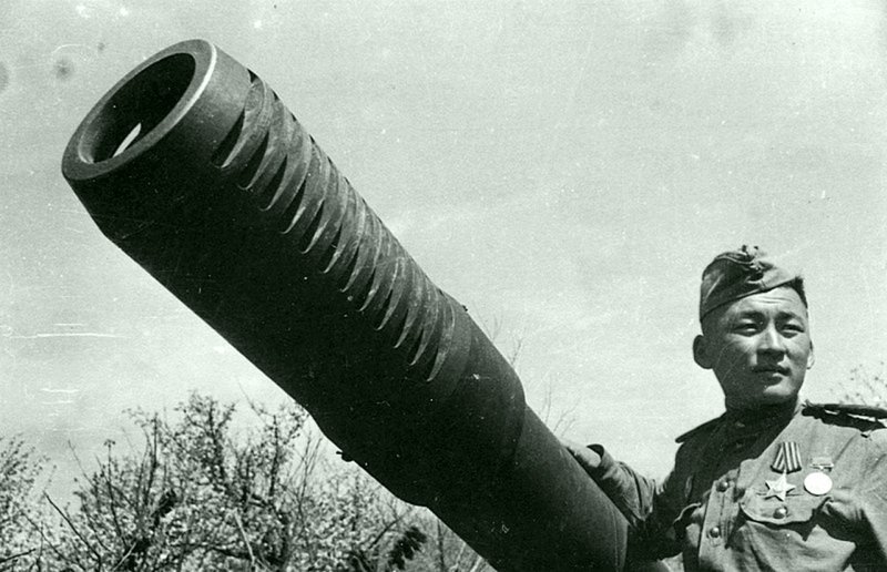 Артиллерист позирует у ствола советской 152-мм гаубицы МЛ-20.