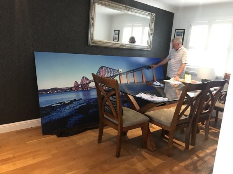 Стюарт Слайсер приобрёл на благотворительном аукционе огромную фотографию железнодорожного моста. Он хотел повесить её у себя дома, но семья была против