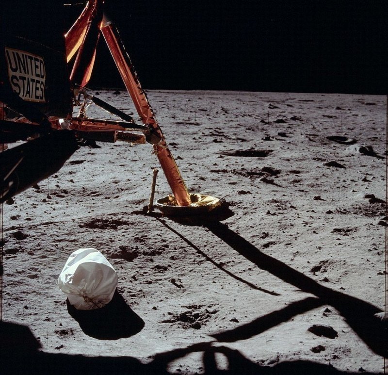 Первая фотография, сделанная Нилом Армстронгом после выхода на поверхность Луны. Белый пакет - мешок с мусором