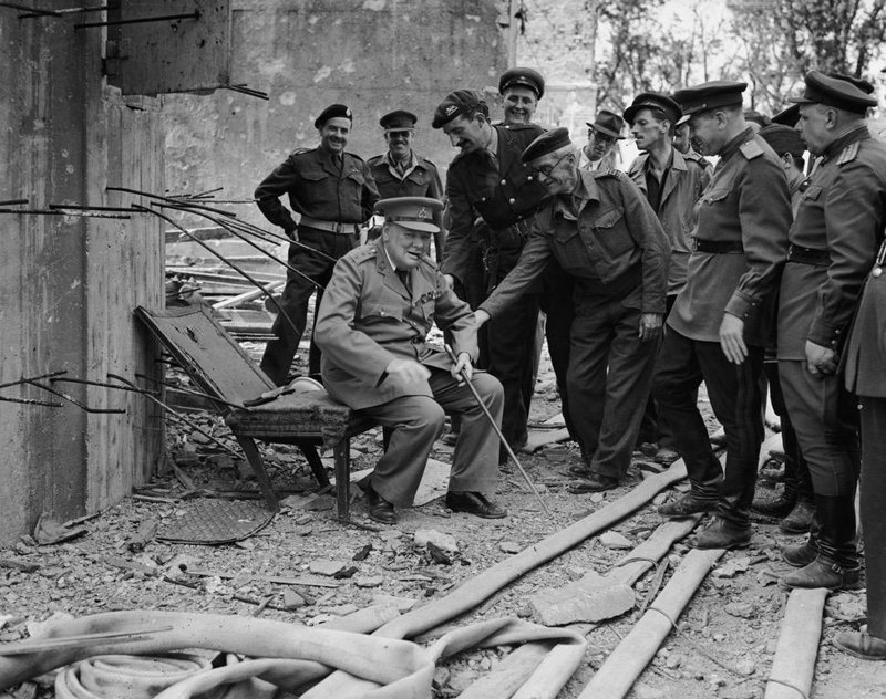 Уинстон Черчилль сидит на том, что осталось от кресла Гитлера. 1945 г.