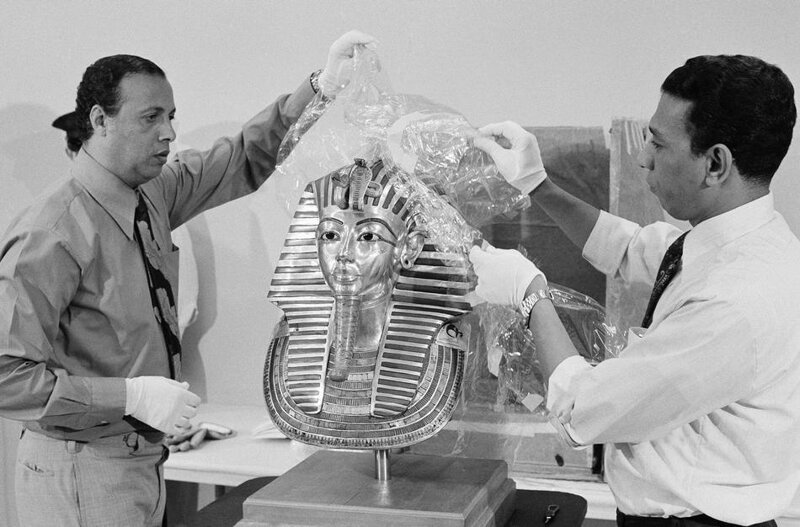 19. Работники Национальной художественной галереи в Вашингтоне убирают защитные пакеты с золотой маски Тутанхамона 8 сентября 1976 года. 