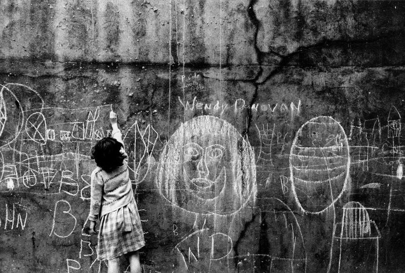 Юная уличная художница. Мелом на стене.