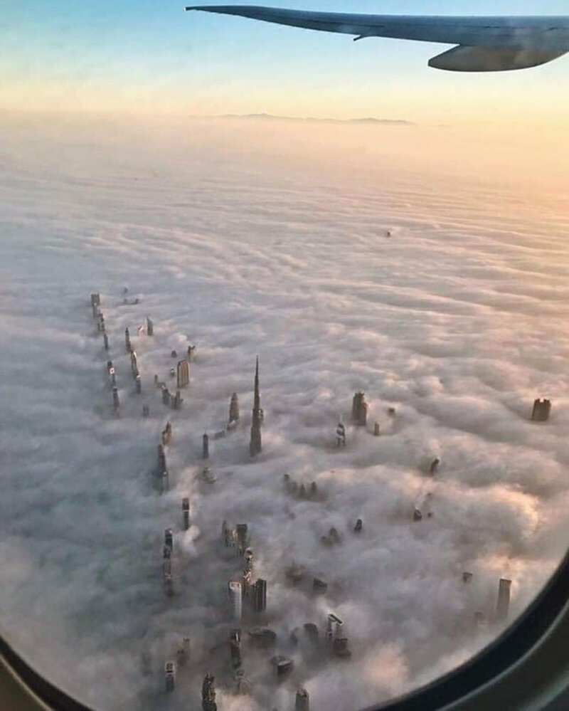  Высокие башни Дубая сквозь облака 
