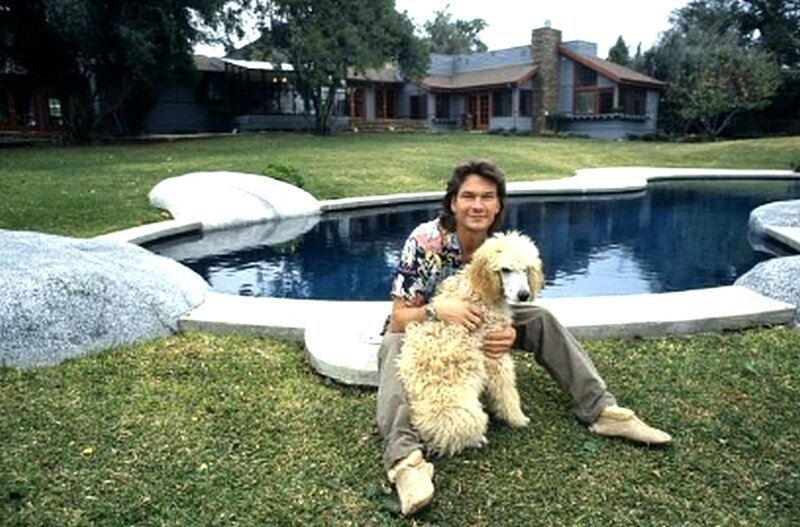 Актер и танцор Патрик Суэйзи позирует со своей собакой дома в 1987 году в Лос-Анджелесе, штат Калифорния.
