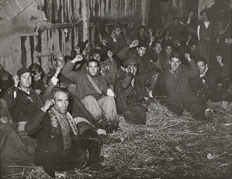 Группа солдат Республиканской армии отдыхает в сарае после перехода через французскую границу 31 января 1939 года