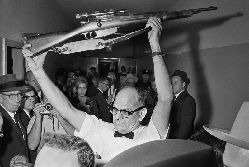 Полицейский Далласа держит винтовку, из которой, по версии следствия, был убит Джон Кеннеди. 1963 год