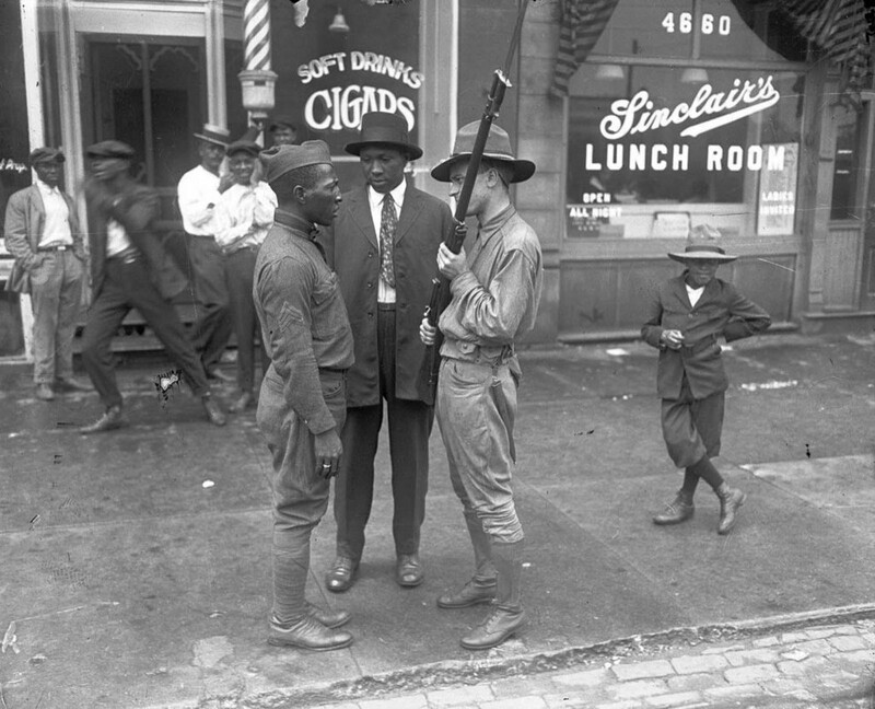Боец ополчения штата противостоит афроамериканскому ветерану войны во время массовых межрасовых столкновений в Чикаго в июле 1919 года