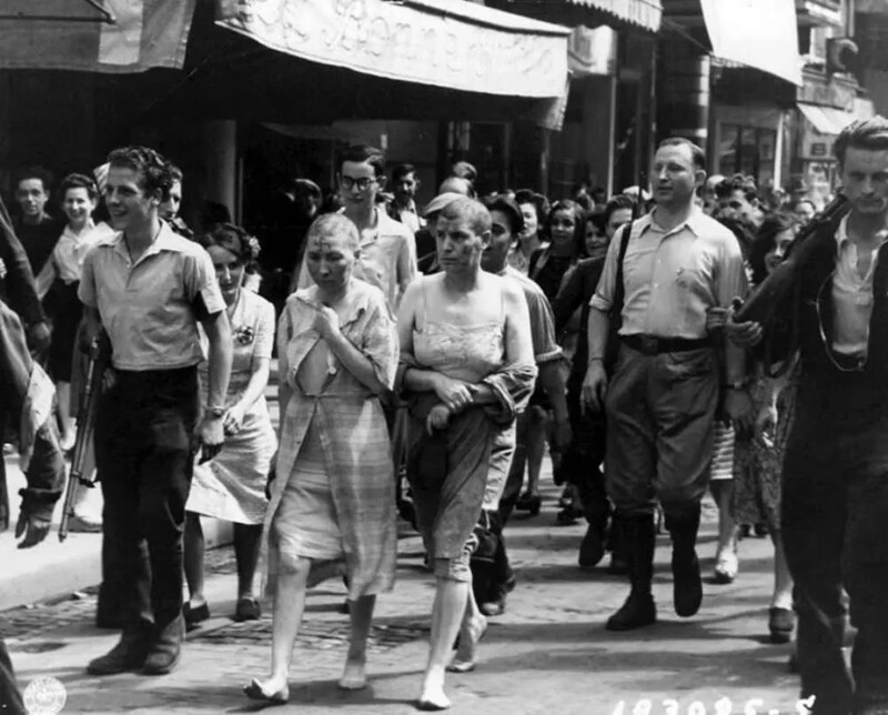 3. Две полураздетые женщины с обритыми головами и с нарисованными на их лицах свастиками идут босиком по улицам Парижа, 27 августа 1944 года