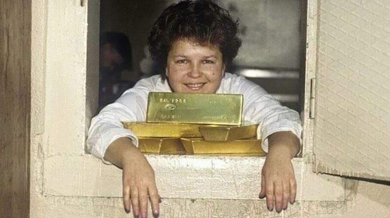 Работница склада драгоценных металлов в Москве позирует со слитками золота, 80-е
