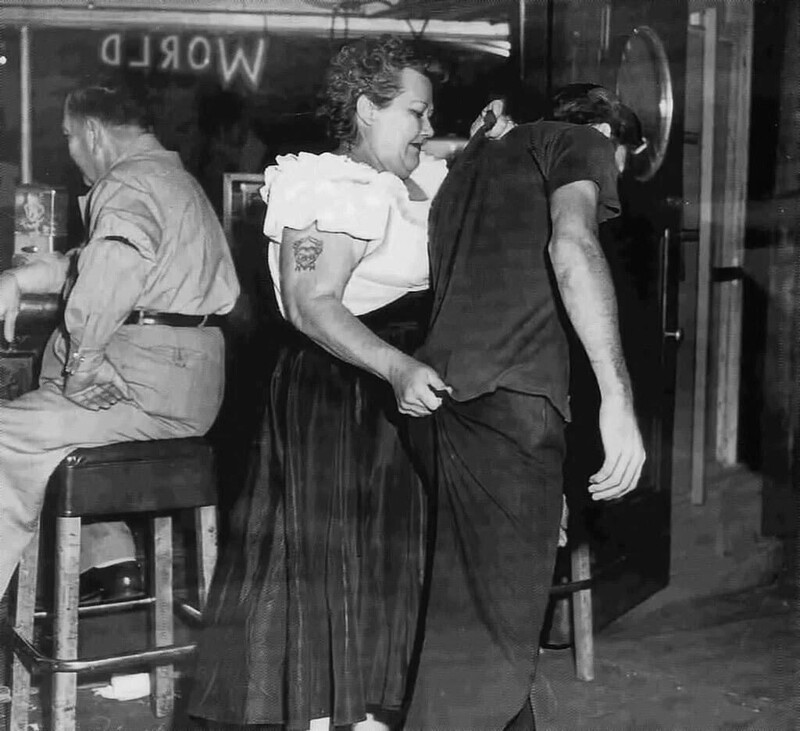 «Каир Мэри», вышибала в Shanghai Reds в Сан-Педро, Калифорния, сопровождает клиента до двери. 1953 год
