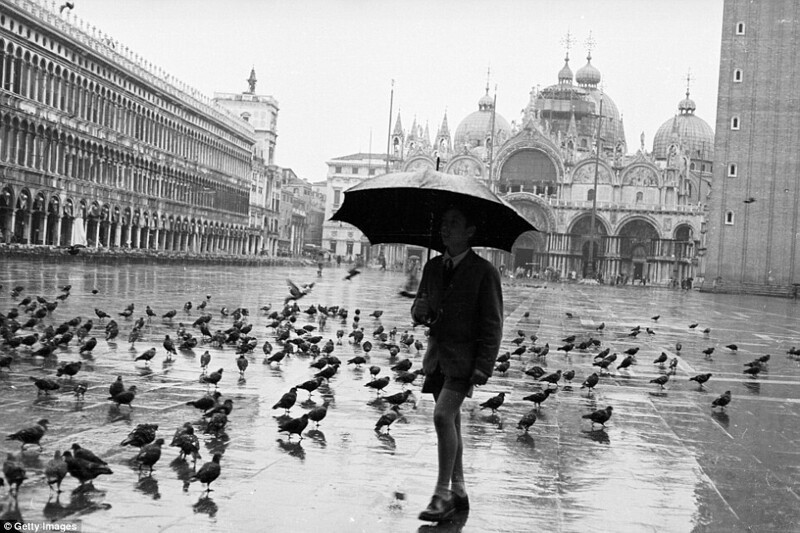 Весенние ливни: школьник идёт под дождём по площади Святого Марка в Венеции, около 1958 года.