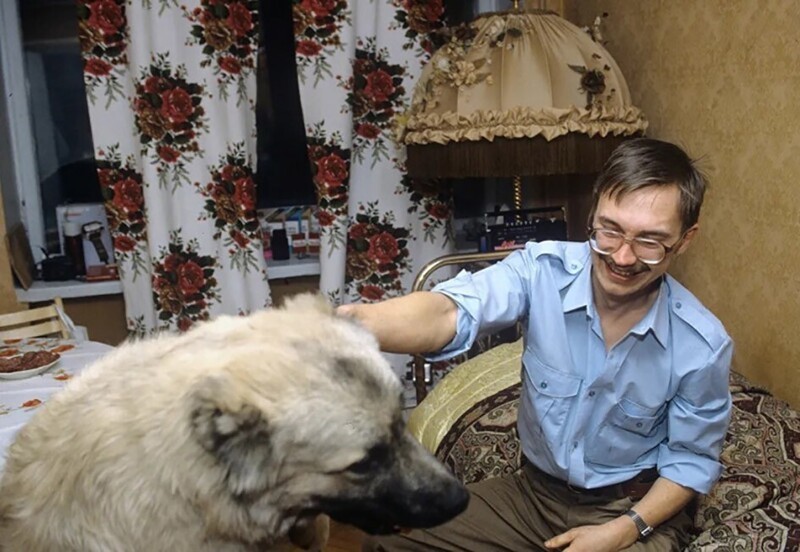 Создатель биржи «Алиса», будущий продавец гробов и хлеба высокой стоимости Герман Стерлигов со своей овчаркой Алисой у себя дома в Москве, 1992 год