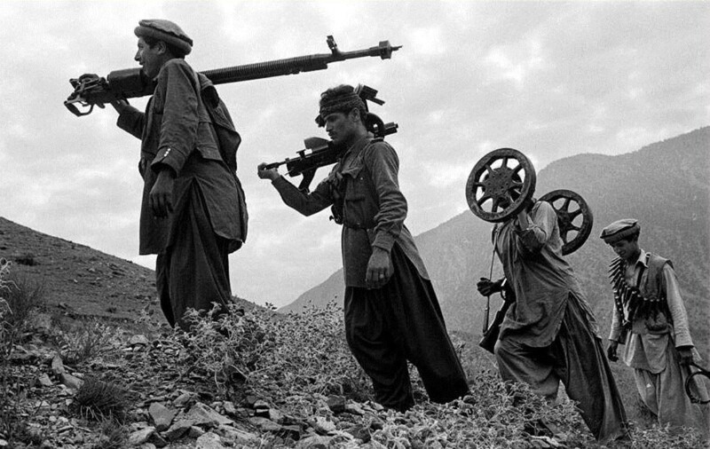 Группа душманов несет разобранный советский пулемет (ДШК) с целью занятия удобной позиции на вершине горы. Афганистан. 1979 год