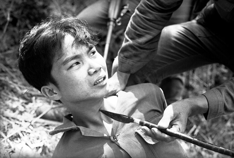 Военные дознаватели Южного Вьетнама ведут допрос с пристрастием захваченного в плен партизана. 28 марта 1965 года