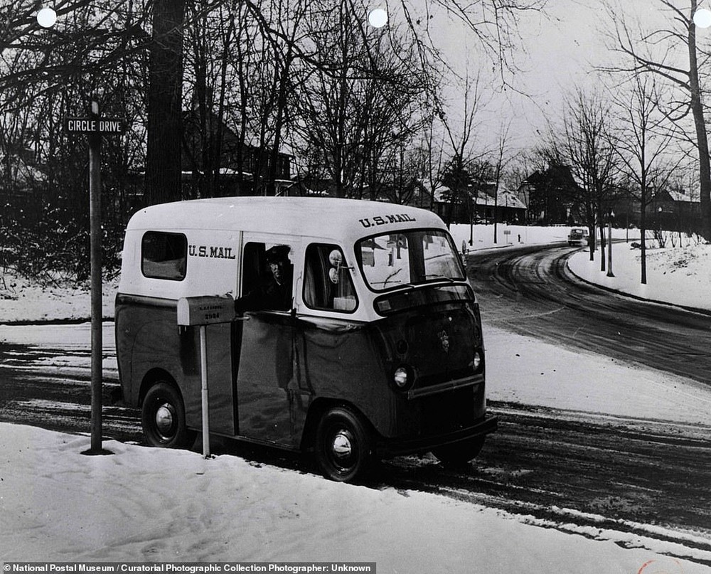17. Почтальон ведет один из новых праворульных фургонов почтового отделения по заснеженным улицам неопознанного города, 1953 год