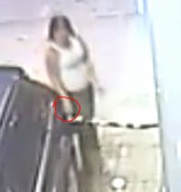 Она её специально поджигает, зажигалкой.

А вот на ютубе это видео в хорошем качестве 720p, так прекрасно всё видно.