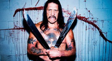 А как же мачетэ,Дэнни Трэхо.  Ни вики написано.
«В кино я попал случайно. Приехал помочь парню, ассистенту чьему-то, насчёт наркотиков. В смысле — слезть с них. Я до сих пор этим занимаюсь — вот сейчас одного актёра из штопора вывожу. И деток в школах про вред наркотиков просвещаю. Так вот. Парень мне позвонил: „Дэнни, тут сплошной кокс, боюсь сорваться“. А это был 1985-й, индустрия по уши в кокаине. И я приехал его поддержать. Гляжу, ходят мужики, наряженные зэками. В фальшивых наколках, тронешь — смазывается. И мой подопечный предложил подработать: „Зэка, — говорит, — изобразить можешь?“ Я в жизни так не ржал: я же во всех тюрьмах штата посидеть успел. Переодеваюсь, а у меня татуировка во всю грудь — и все сразу такие: „Ого“. Потом дядька подходит: „Трехо, здорово. Помню, как ты первенство Сан-Квентина в полусреднем весе выиграл“. Смотрю — Эдди Банкер, мы с ним чалились. Оказалось, он сценарист. Спросил, боксирую ли я ещё; типа у них один актёрик, надо его подучить. Я говорю: „В массовке 15 баксов платят, а тренер сколько получает?“ А он: „320. Только ты с парнем потише, он дёрганый“. 320 в день! За 320 я Годзилле навалять мог. И я стал тренировать Эрика Робертса. Он меня вроде побаивался. Что скажу, то и делает. Это увидел Андрей Кончаловский, а у него, кажется, с этим проблема была — Эрик его не особо слушался. И он мне дал роль. Подошёл такой: „Беру тебя в фильм. Будешь Эрика бить“. Потом история несколько раз повторялась — прихожу в массовку, а меня вытаскивают из толпы. Пять лет я играл Уголовника № 1, говорил всегда одну фразу, обычно: „Гаси их!“ Один режиссёр дал дробовик и говорит: „Высади ногой дверь, а там импровизируй“. За дверью люди как бы играли в покер, каскадёры, понятно. Ну я вышиб дверь, кто-то вскочил, я ему заехал прикладом, тёлка какая-то визг подняла, а я ей раз — дробовик к виску. Режиссёр сам не свой: „Боже, Дэнни, где ты этому учился?“ А я: „Дай вспомнить. Супермаркет Von’s я брал. И Safeway. И Thrifty Mart“. Короче, опыт был»