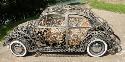 Наверное,не намного больше веса"родного"кузова,т.к.вот,по-моему,аналогичное произведение кузнечных дел мастеров,разница в весе + 85 кг.