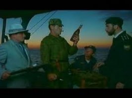 Ящик был у вас?
- Какой такой деревянный ящик?
- У нас ящик был на баркасе?
- Был. Сзади стоял.
- Да, на корме стоял деревянный ящик.
- Ну давай хотя бы тащи ящик этот.
- Принимаю, давай. Тяжеленький.
- Любопытный погребец.
- Коньяк. 1804 год. Год провозглашения Наполеона императором Франции. А до этого он был простым пожизненным консулом.
- А он хороший? Коньяк?
- Французский, почти 200 лет.
- Никогда такого не пробовал. 200 лет. Это ж какая выдержка! Звездочек со всех погон на нашей базе не хватит.
- Такой коньяк, раритетный, только на мировых аукционах купить можно.
- А сколько он может стоить?
- Очень дорого. Нам такого никогда не купить. И никогда не попробовать.
- А зачем покупать? Вот он.