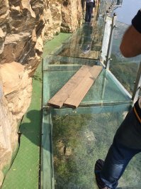 Был я на этом мосту. Когда увидели треснутое стекло с досками через него, рассмеялись в голос, перешагнули и дальше пошли.