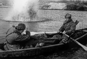 Великая Отечественная война. Санинструктор сержант В. Росликова оказывает помощь раненому. Гребёт боец В.И. Шестаков. 1943 год