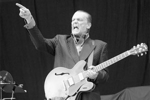 если мордатого узнают многие, то чувака с гитарой скорее только люди, живущие в Америке. А волосатый - подсказка - Металлика пела его песню, оч оч оч знаменитую.