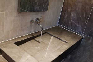 это и есть раковина. а стык со стеной где зеркало - там слив. есть вариант слива в бок (вторая картинка) 
прикольная, надо сказать, задумка.