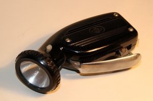 Для подзарядки телефона и такой динамомашинки  достаточно.Нужно только мост (выпрямитель)добавить.И размерами поменьше и посветить можно.Еще и кисть подкачаешь.))