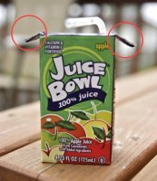 Отработал в Тетра Пак 6 лет. (еще до слияния с Альфа Ловаль)
Возможно за эти "крылья" действительно удобно держать пакет, но вот их первостепенная задача совсем не в этом.
На фото мы видим упаковку, которая называется "Тетра Брик Асептик". В нашем случаи ключевое слово "брик" (кирпич по нашему). Рулон бумаги пройдя "дизайн-коррекцию" на подходе к "драйв-юнит" имеет вид трубы. Далее формируются пакеты, но они еще не "брик". Окончательное формирование происходит на этапе "файнел-фолдер". Как раз там и придаётся окончательная форма кирпича, для чего уголки сгибаются и приклеиваются.