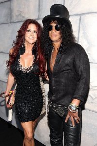 Slash тоже в чёрной шляпе и круглых очках, да и прическа похожа.