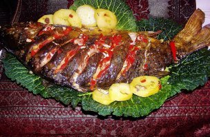 Пакет - это только для неумех. К тому же - слишком долго в духовке. С маринованием в течение четырёх часов у меня тоже есть сомнения в целесообразности.
Вот вам мой карпик весом 1 кг 800 гр. Начинённый смесью мелко нарезанных томатов, чили, лимонного сорго, чеснока, рыбного соуса и красной пасты карри он понежился всего-то 35 минут в раскалённой до 220 градусов духовке и выскочил оттуда хрустященький и ароматный аж до восторженного писка.