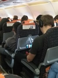 Нечто подобное сразу в голову пришло, когда в больнице лежал :)
Розетка высоко, не знаю почему, почти метра два. Поблизости ничего нет положить телефон, да и выпадал он когда висел на шнуре (у меня была книга на электронных чернилах, слушали музыку всей палатой, поэтому часто садился).
Ну дак просто положил в обычный пакет его, приложил верх пакета к розетке и просто проткнул вилкой зарядника. 
И ВСЕ! :)