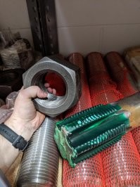 Эта гайка напомнила давнюю байку из интернета:

Давным-давно, в конце боевых 80-х моя жена работала после МАИ на НПО Лавочкина (спутники там всякие делают). Проектировала она там в КБ. И вот один раз звонят ей из цеха опытного производства и говорят:
- Срочно приходите, с вашей деталью тут проблемы.
Бежит она в цех, прихватив чертежи. Навстречу ей - начальник цеха.
- Вы, - говорит, - чертили деталь >?
- Я, - отвечает жена, - а что за проблемы?
- Да вот, полюбуйтесь, - говорит начальник цеха, и машет кому-то рукой. В ответ появляются два работяги, которые тащат гайку весом килограмм на 30 и диаметром в полметра.
- Это, - говорят, - ваша ошибочка, что там за размеры вы проставили? Сантиметры?
С женой сделалось дурно и все чертежи выпали из ее рук...
Потом оказалось, что это избитая шутка цеха и гайка была сделана лет 10 назад для создания чувства ущербности у молодых специалистов.