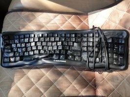 Это не разбитая вдрызг, а опаленная клава. Если и возможно так разбить, то работать она перестанет задолго до этого.