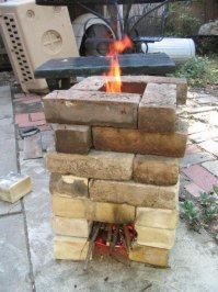А что если просто купить шестнадцать-двадцать кирпичей?
Печка ракета.

и вот ссылка на статью про разные простейшие печи