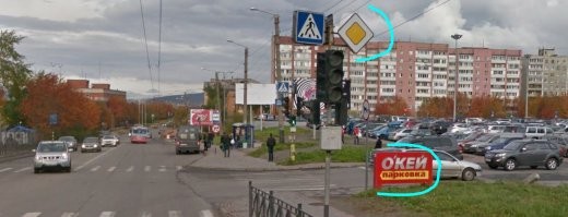 Дороги прилегающими не бывают, есть дороги на прилегающей территории (не уверен, вроде бы правильно сказал). 
Выезд из прилегающей территории будет считаться дорогой (или нет, неважно), но считаться перекрёстком  точно не будет (а вот это важно): на улице Шмидта я вижу декоративное обозначение парковки ТЦ "Окей" и знак главной дороги, который не перестаёт действовать за выездом из парковки, так как это не перекрёсток. Следующий выезд из парковки, даже если и не понятно, знак главной дороги всё ещё в действие для едущих по улице Шмидта. Я правильно понял вопрос?