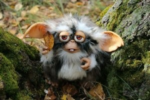 Чебурашка с зубами, похож на гремлина.