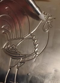 В магазинах для самоделок продавалась такая тонкая жесть, продавливалась тупой палочкой, но не рвалась..
Из неё начал делать псевдо-чеканку, легко и просто. Было здорово, выглядела, как настоящая чеканка. Главное, -- найти подходящий для выдавливания рисунок.
Показать нечего, давно было. Мне ~8-10 лет, значит в 1970-72 годах. Фото из сети